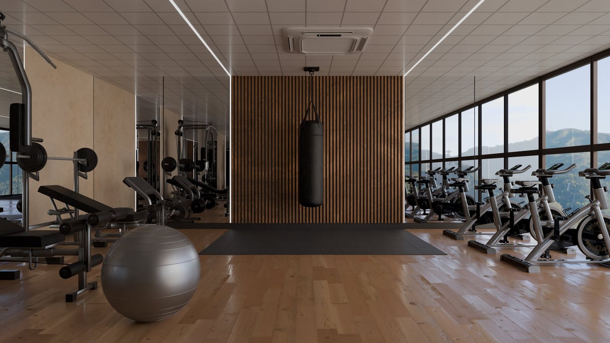 People can work out in a gym that features various fitness equipment. area has a punching bag, exercise bikes, and a big exercise ball in a well-lit setting. 3d render.